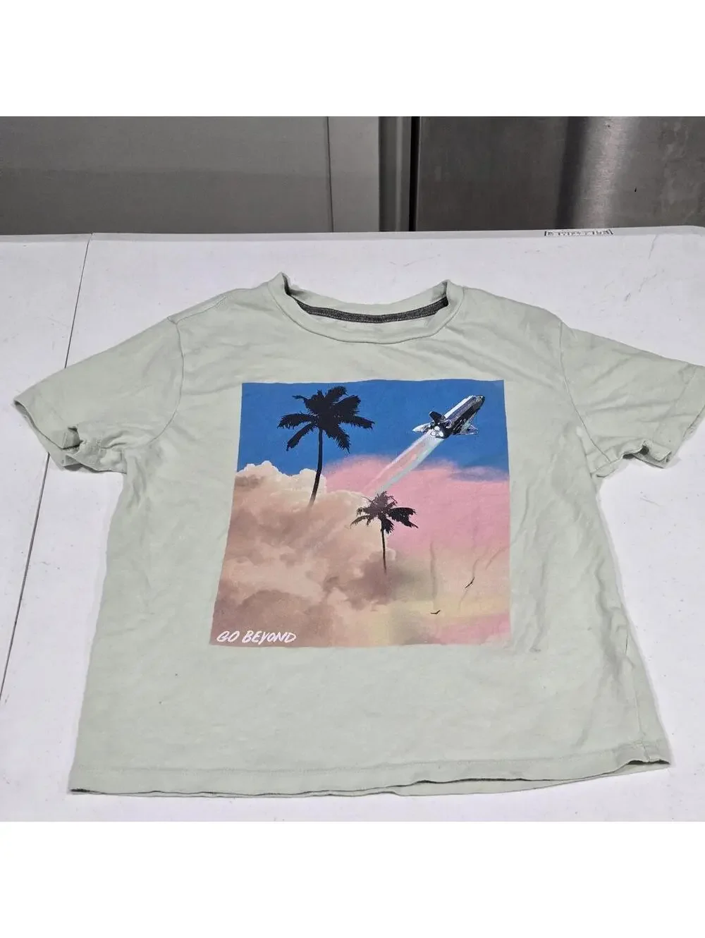 -Light green Old Navy graphic tee with palm trees and a rocket